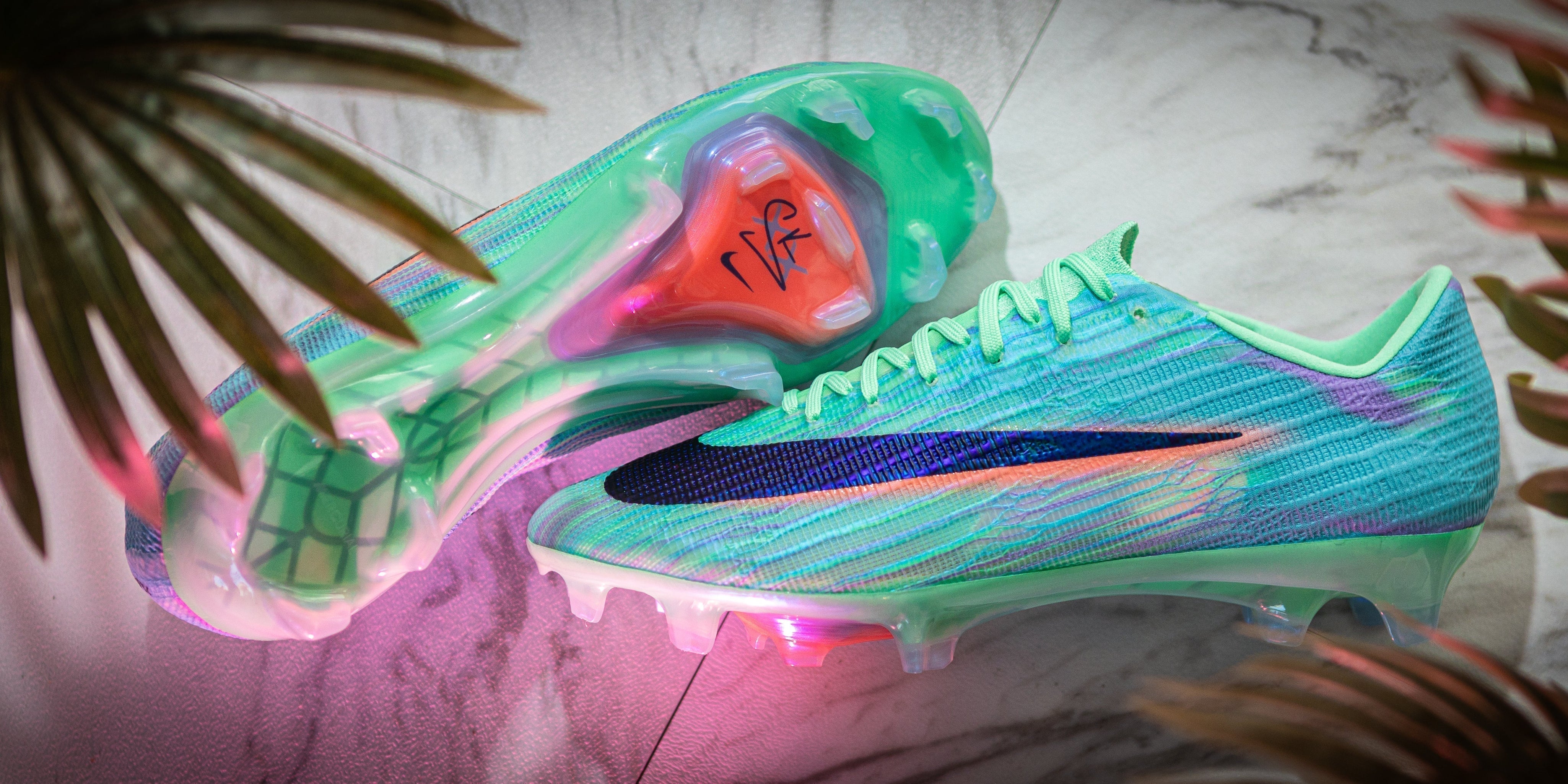 Side profile and soleplate of the Nike Mercurial Sam Kerr Special Edition football boot on marble with palm leaves