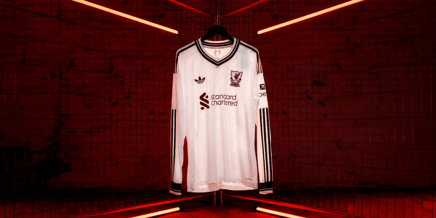 27 Away Jersey in white with deep red details, displayed under red lights