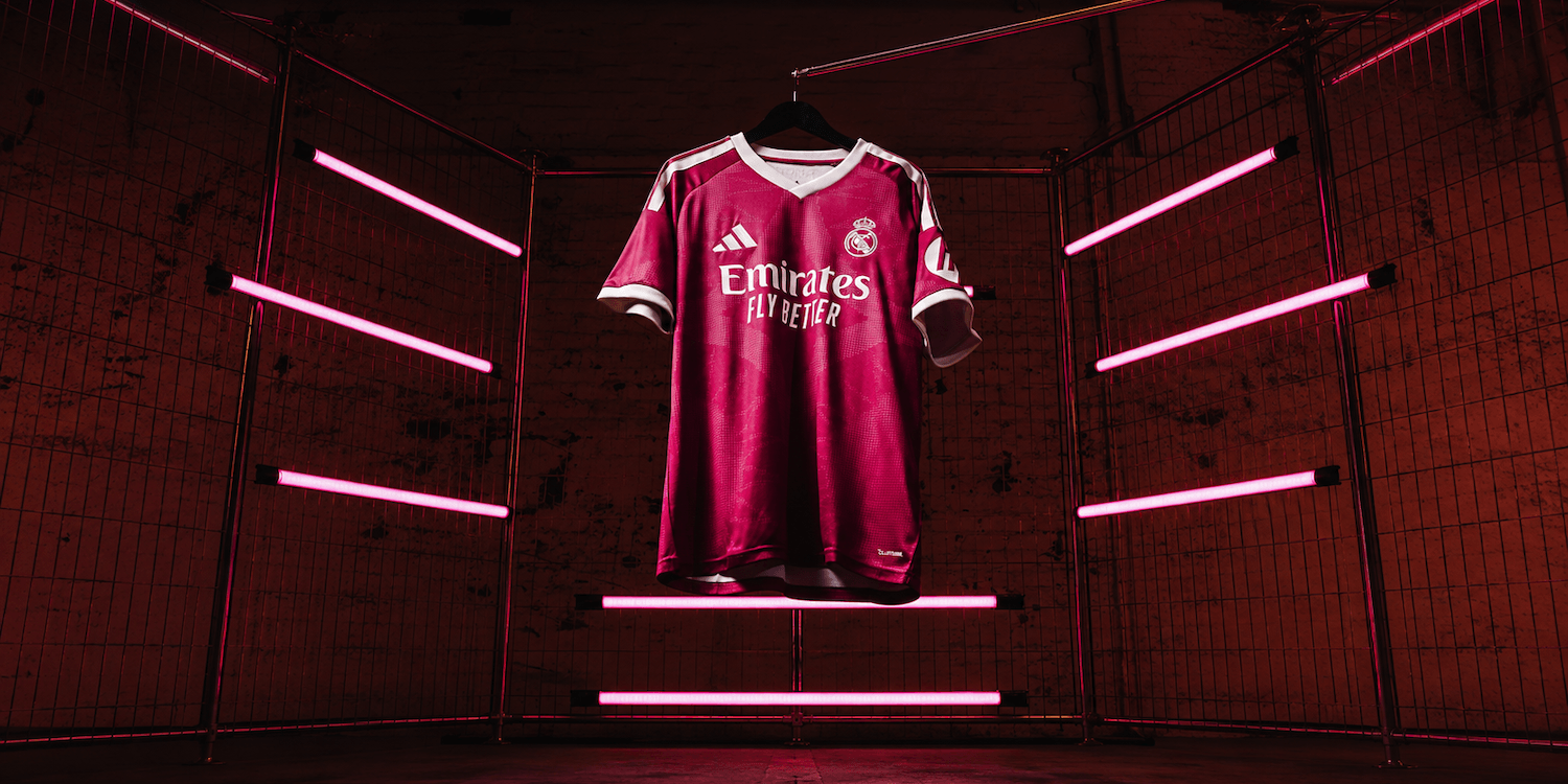 27 Third Jersey in rich pink with off-white details, suspended among pink neon lights.