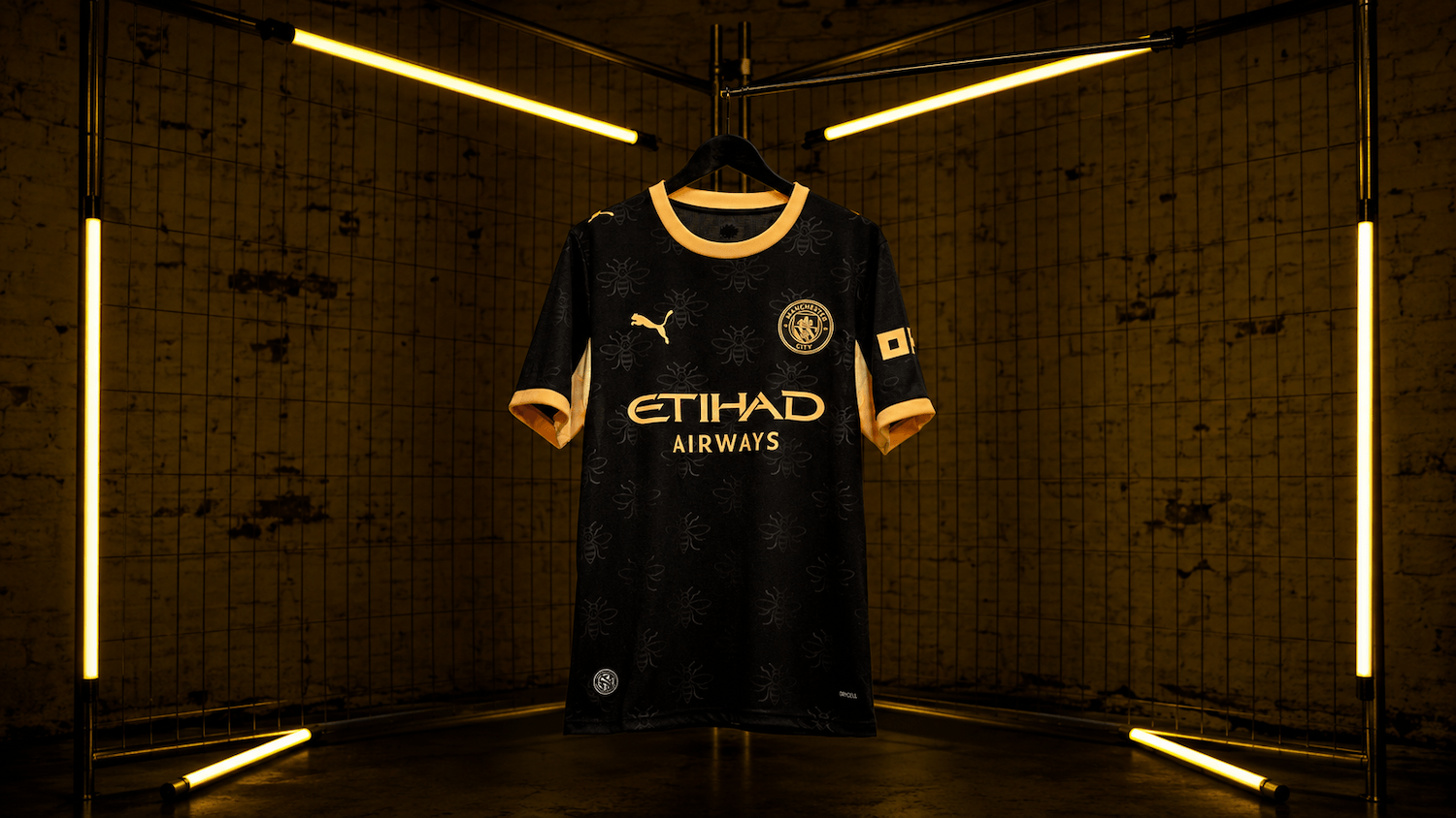 27 Away Jersey in black with gold details and worker bee pattern